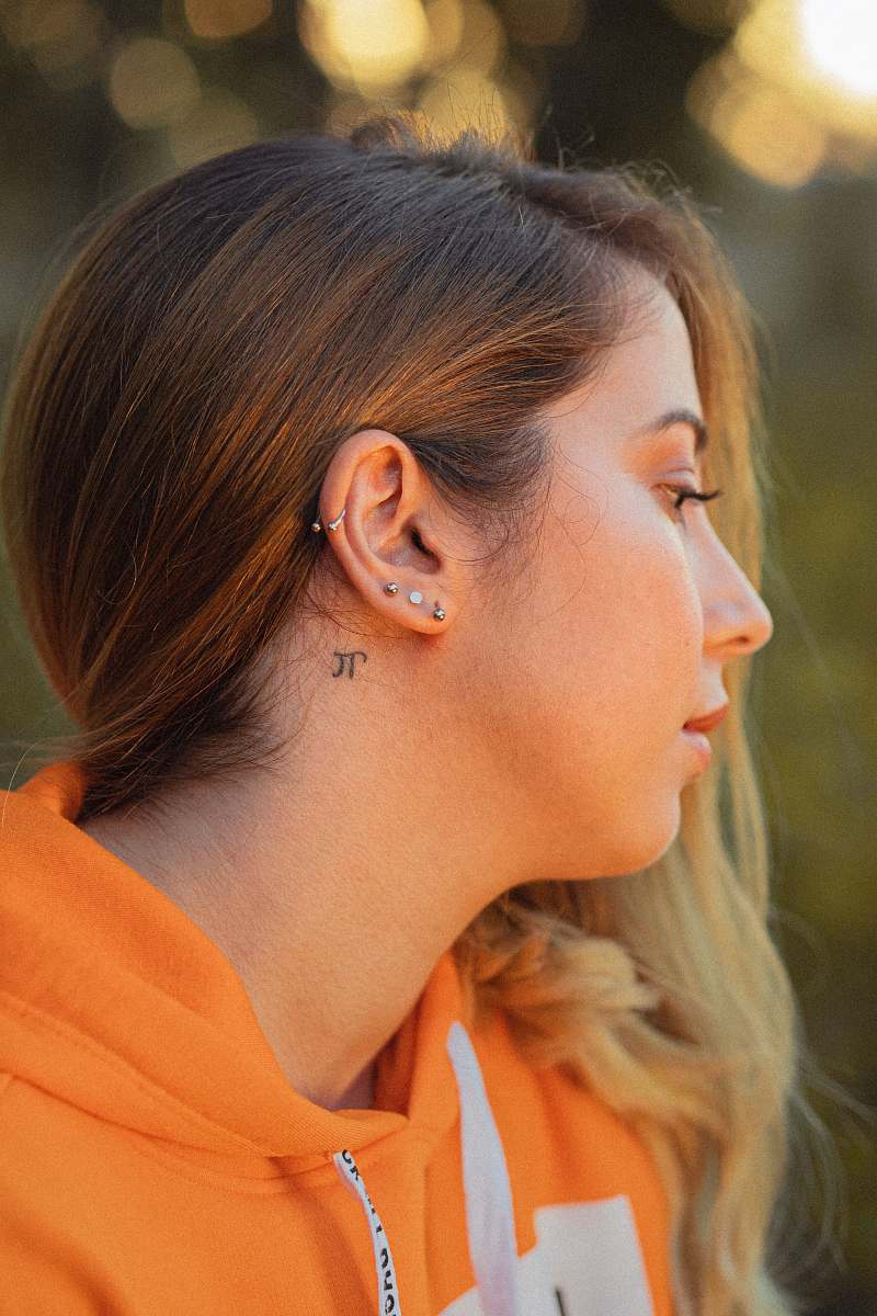 human shallow focus photo of woman in orange hoodie hair