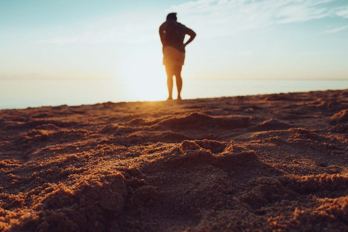 human standing person on brown sand mauritius
