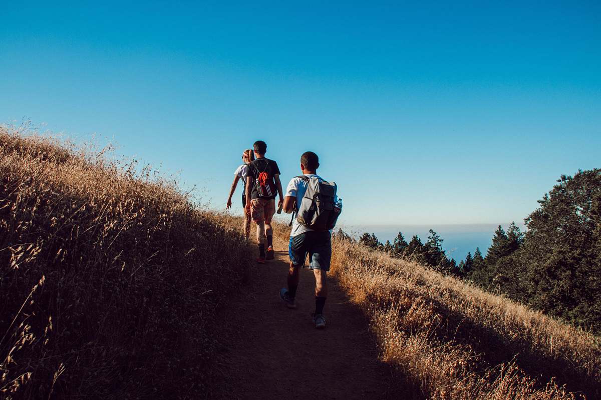 human three person hiking on mountain walking
