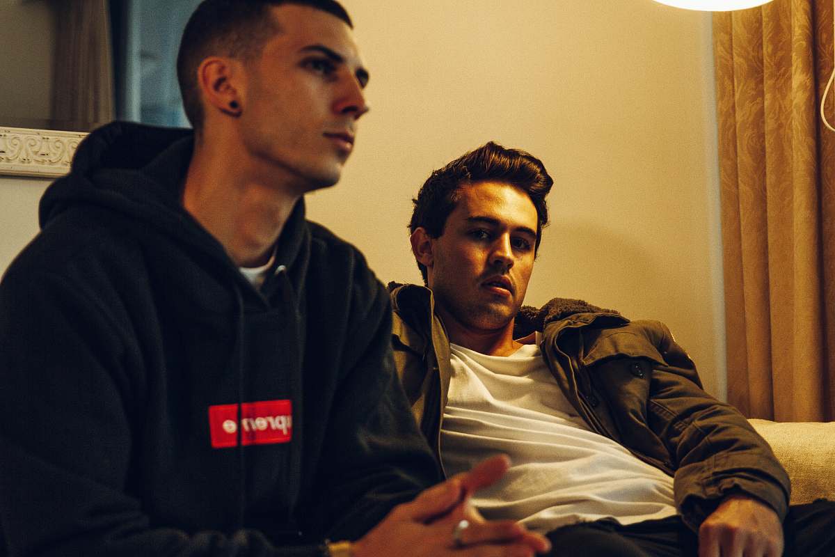 human two man sitting inside room sitting