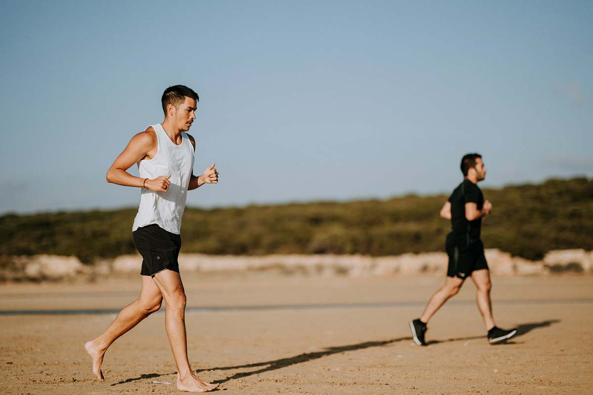 human two men running on field people