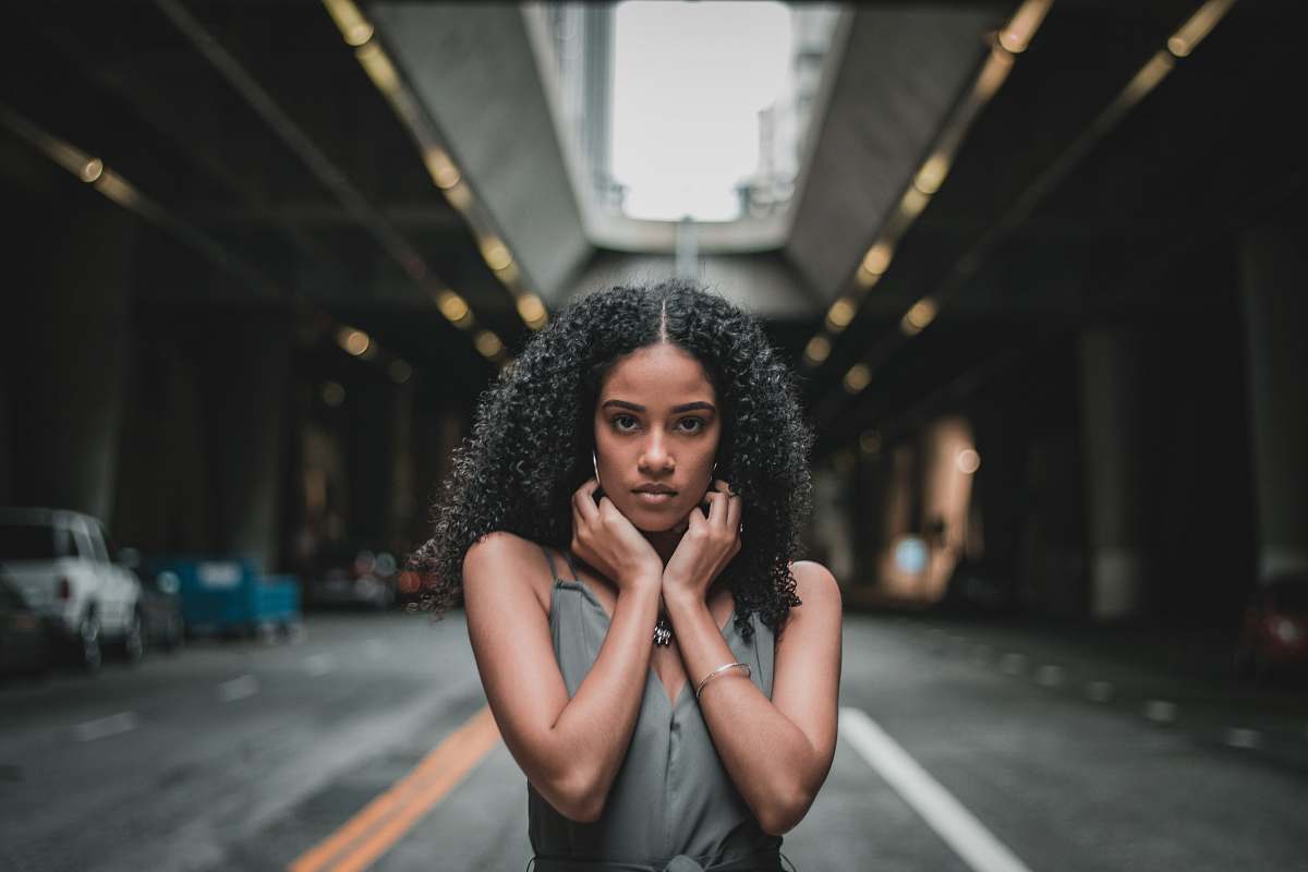 people woman doing pose on asphalt road hair