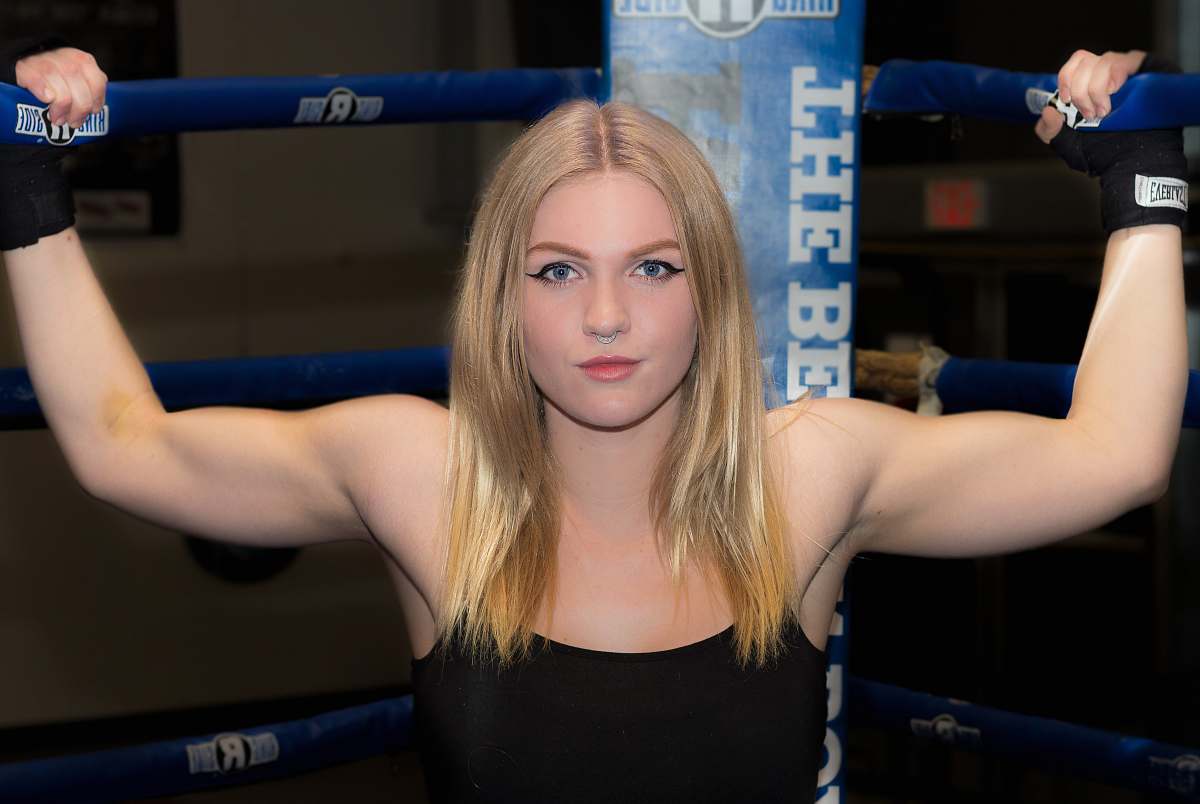 human woman gripping boxing rink with both hand sport