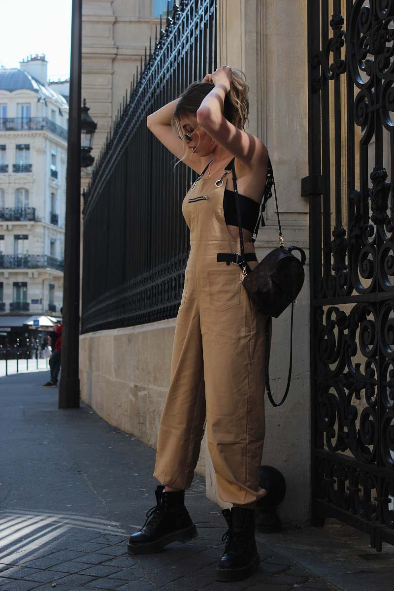 human woman holding hair by both hands while standing outdoor people
