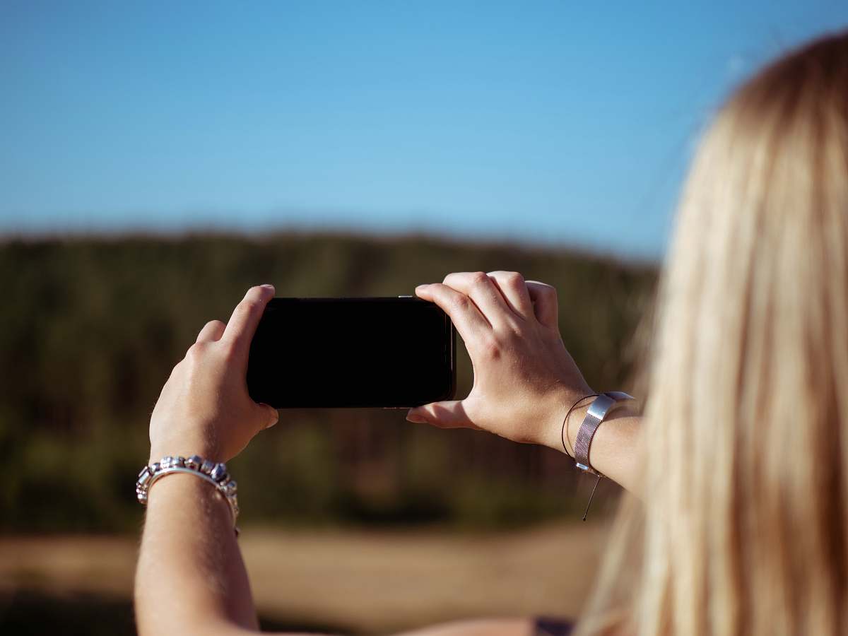human woman holding smartphone people