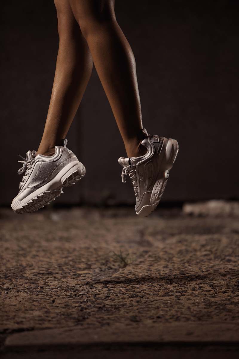 apparel woman jumps using white sneakers clothing