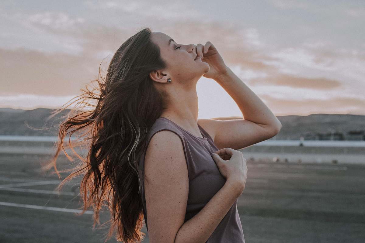 human woman looking up with eyes closed during daytime people
