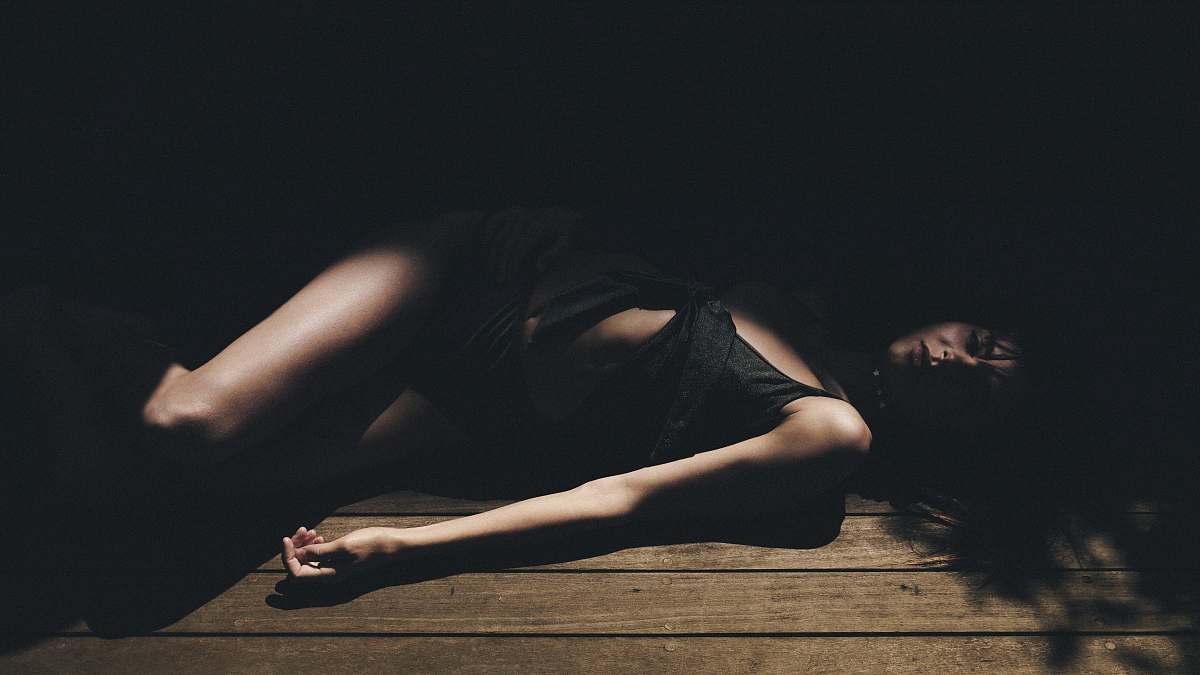 people woman lying on brown wooden floor human