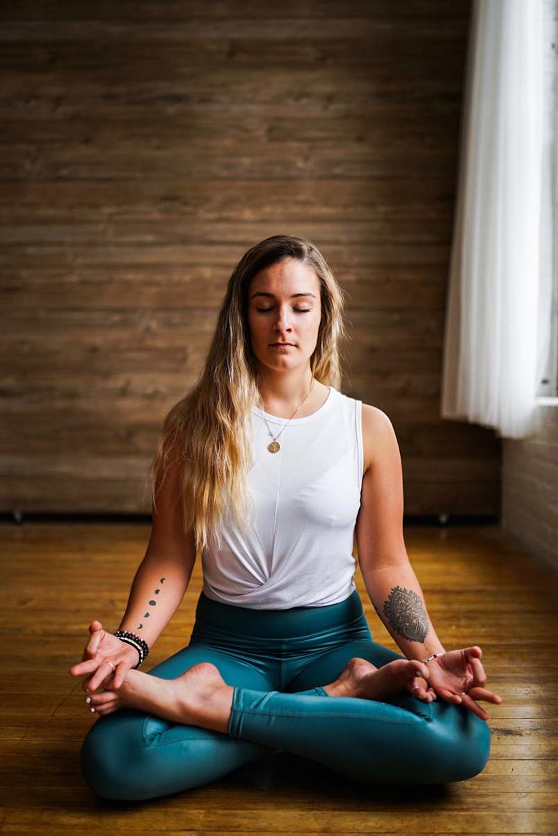 wood woman meditating inside room during daytime hardwood