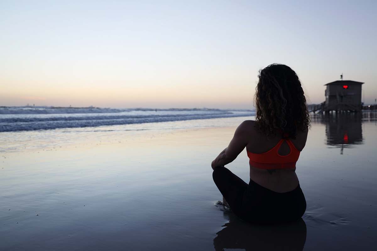 human woman seated on shore sport