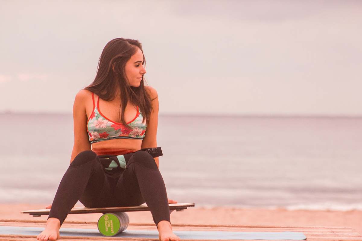 human woman sitting on board balancing on canister female