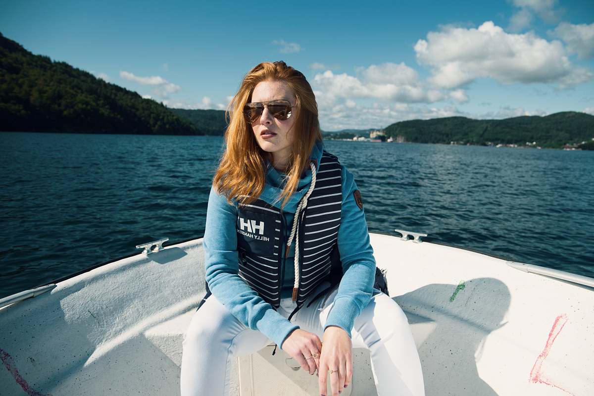 boat woman sitting on boat near mountain during daytime people