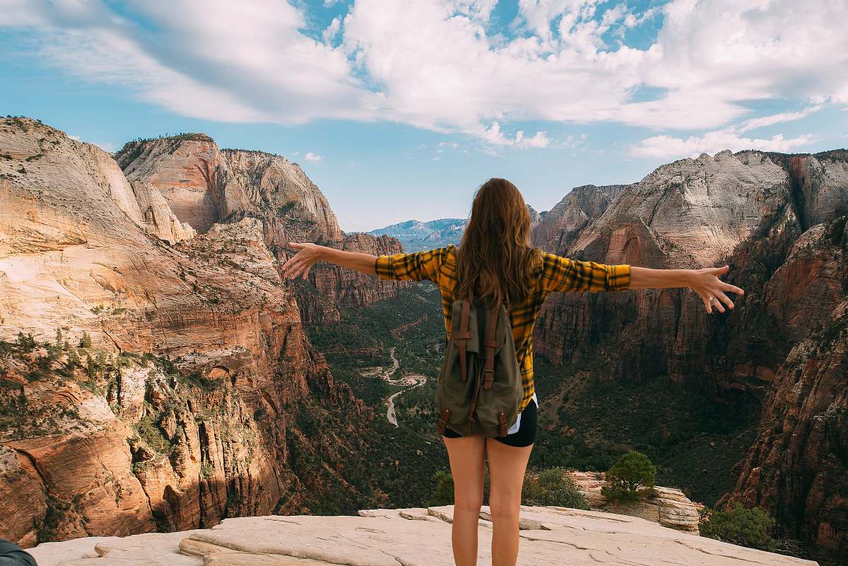 nature woman spreading her hands white standing on mountain cliff woman