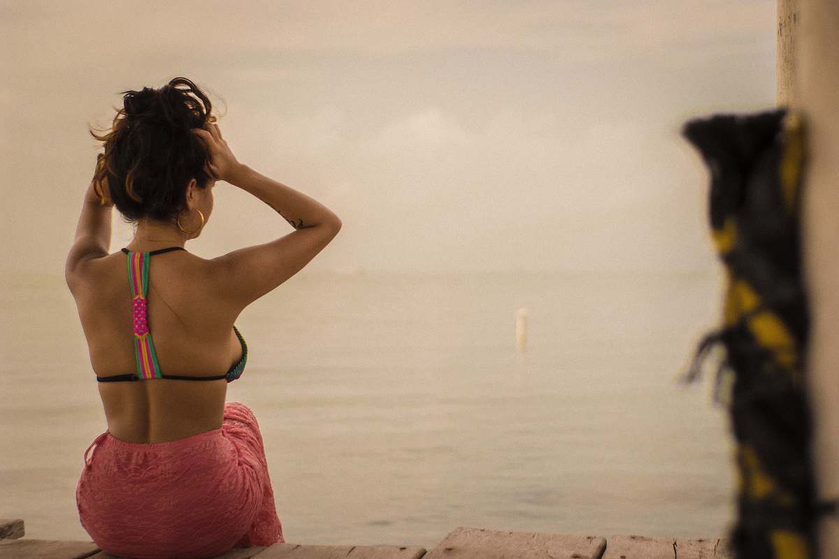 human woman wearing black halter bikini top back