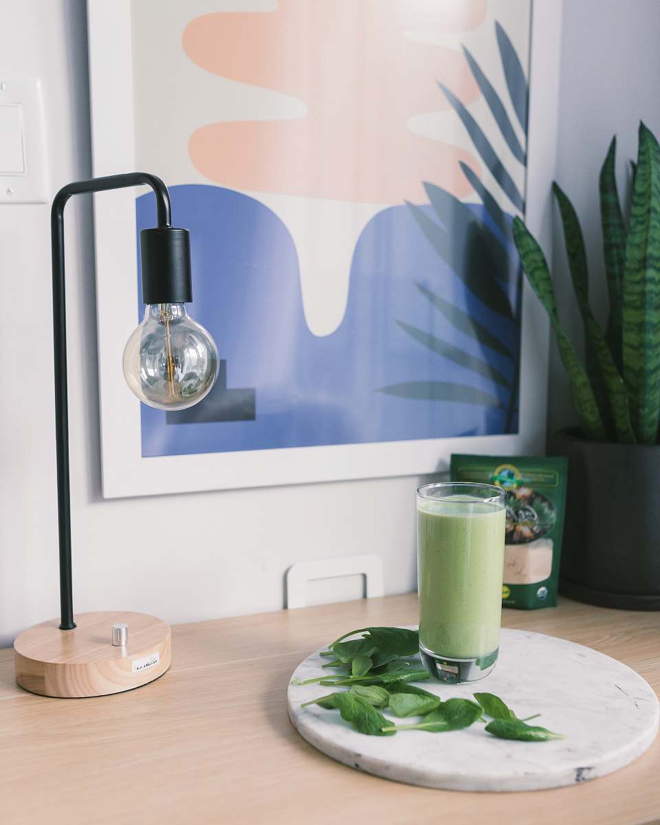 beverage clear drinking glass on top of table near desk lamp drink