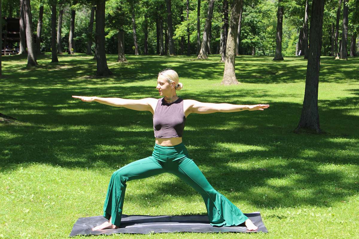 human woman doing yoga grass