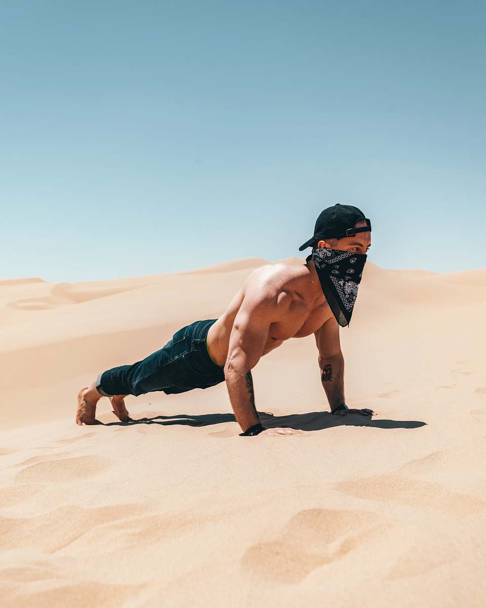 sand man pushing up on dessert nature