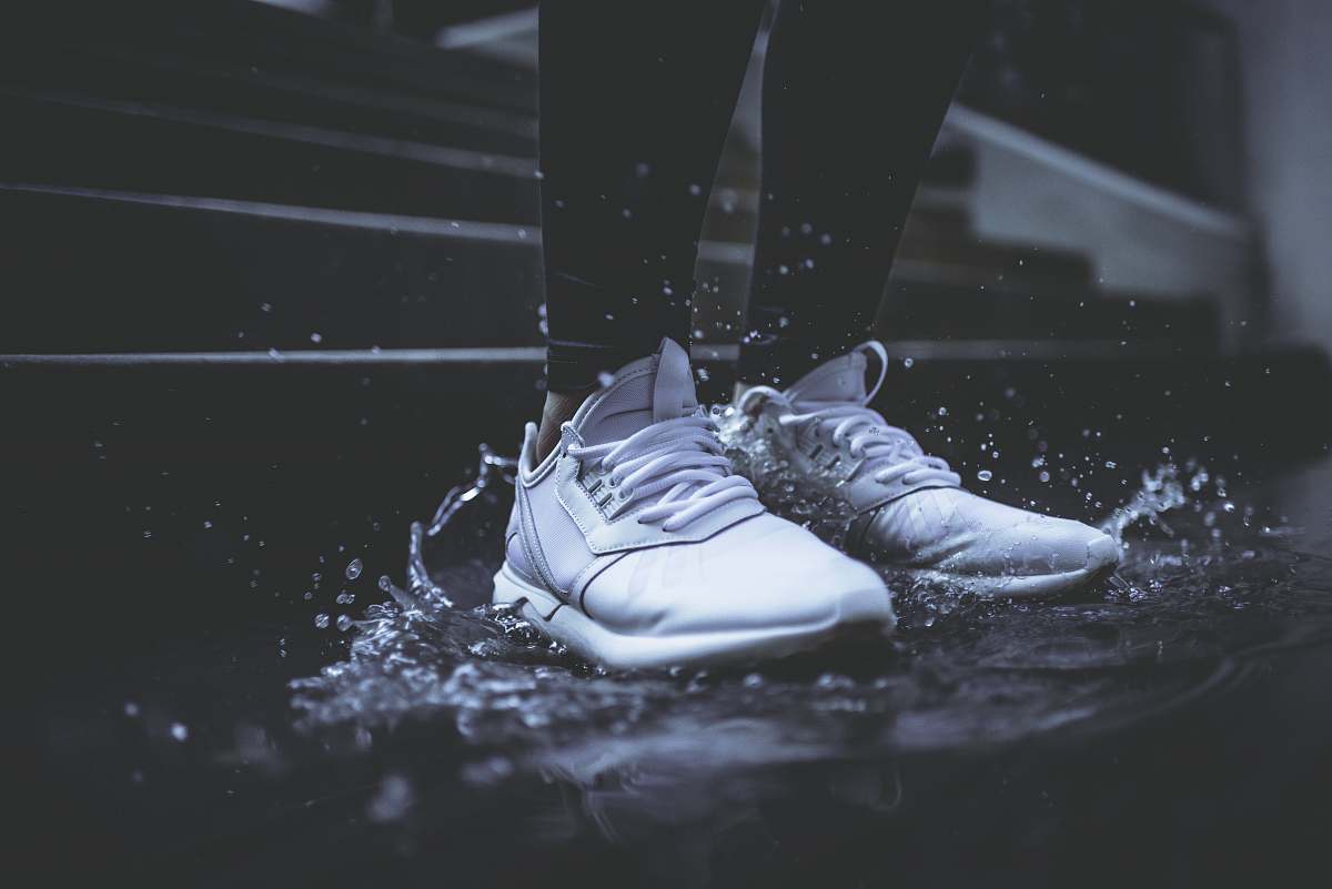 water person standing on body of water shoes