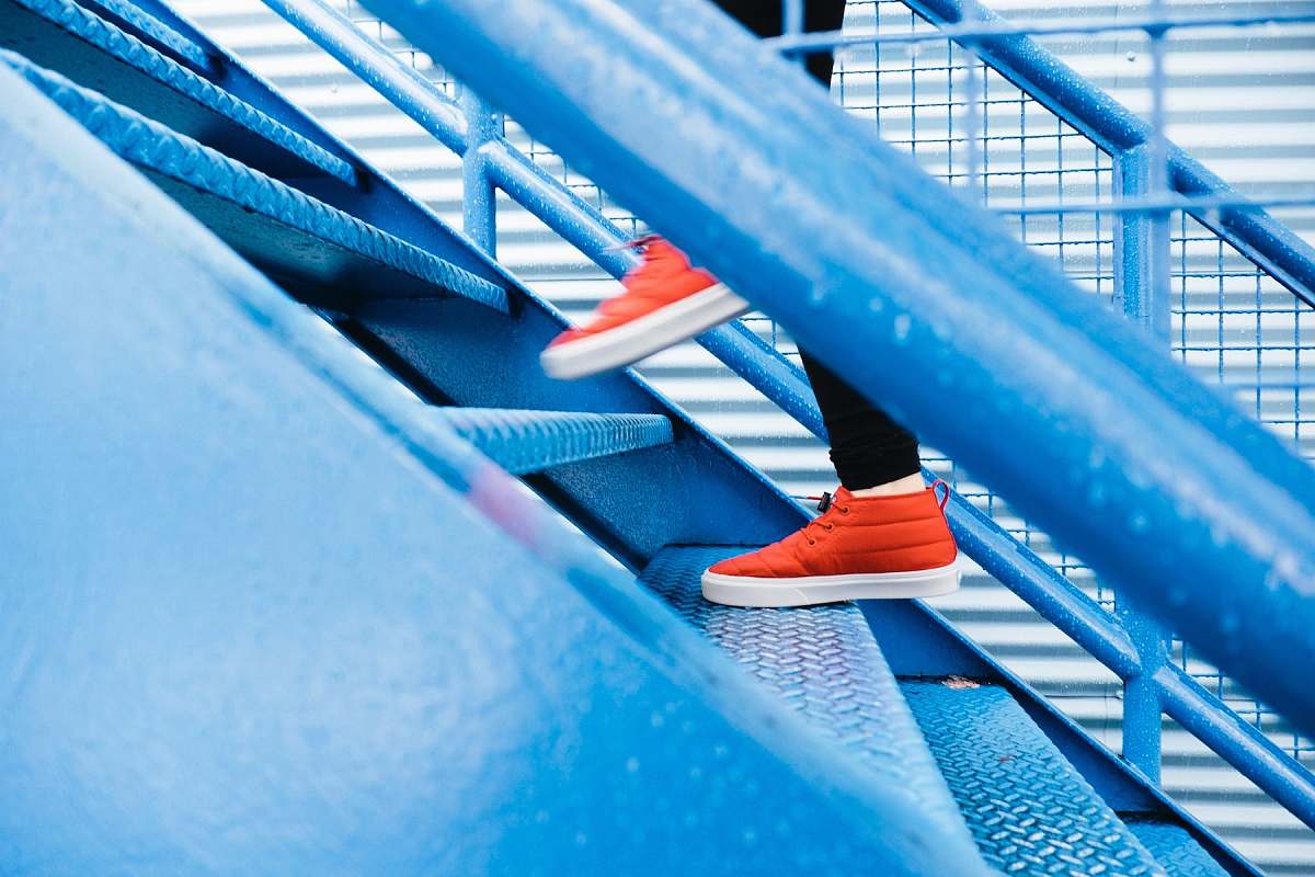 stairs person stepping on blue stairs red
