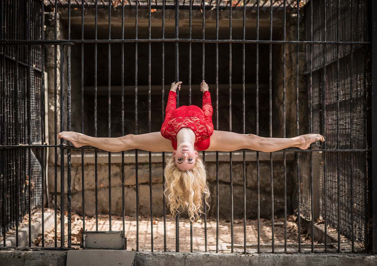 toy woman bending her legs on metal cage old los angeles zoo