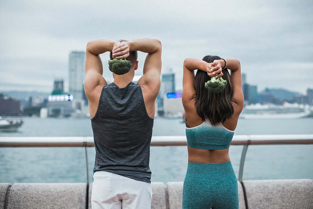 apparel woman standing beside man during daytime clothing