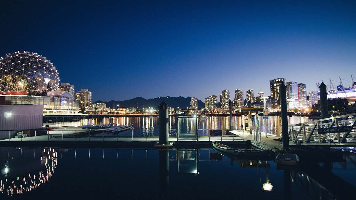 city boats docked near concrete structures canada