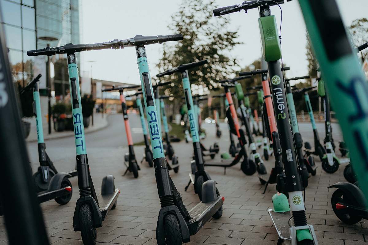 transportation electric scooters parked on sidewalk machine