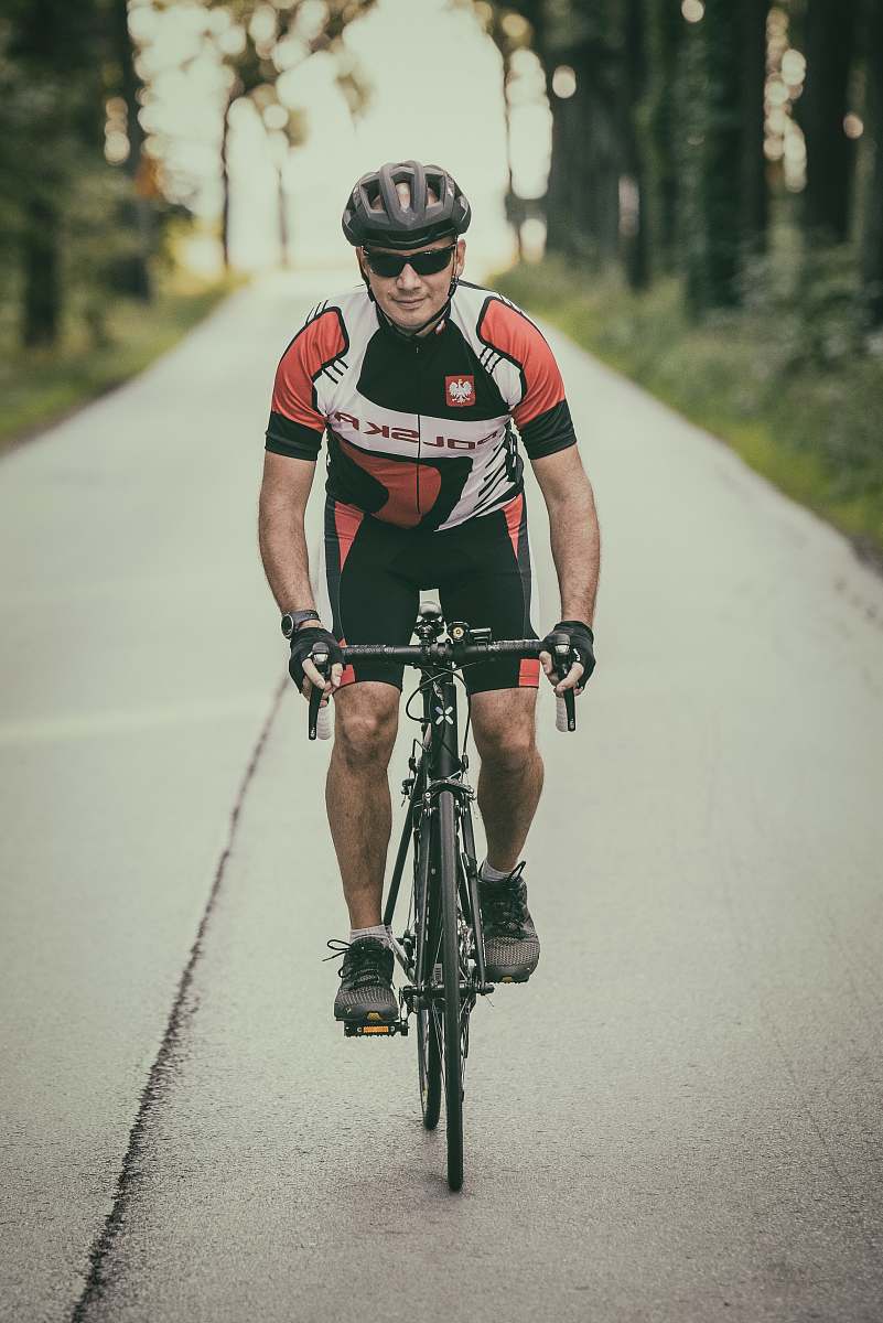 bike man riding road bike on concrete road during daytime bicycle