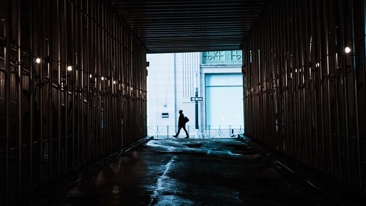 manhattan person walking in front of tunnel new york
