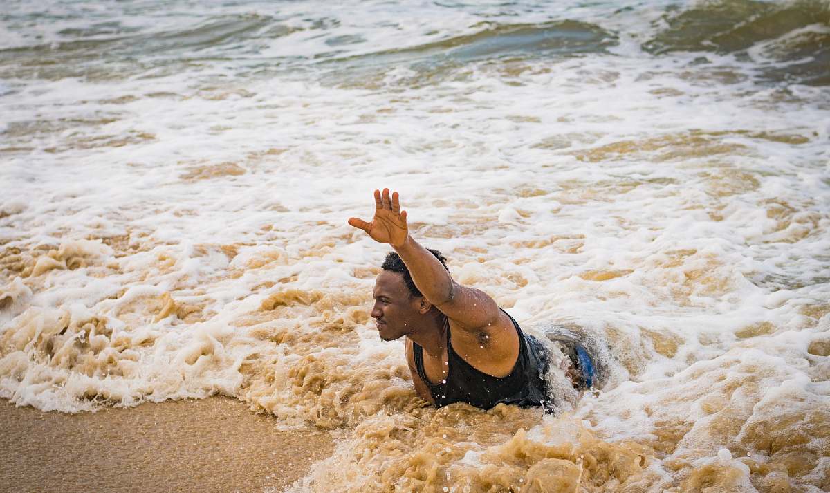 nature man swimming on beach during daytime ocean