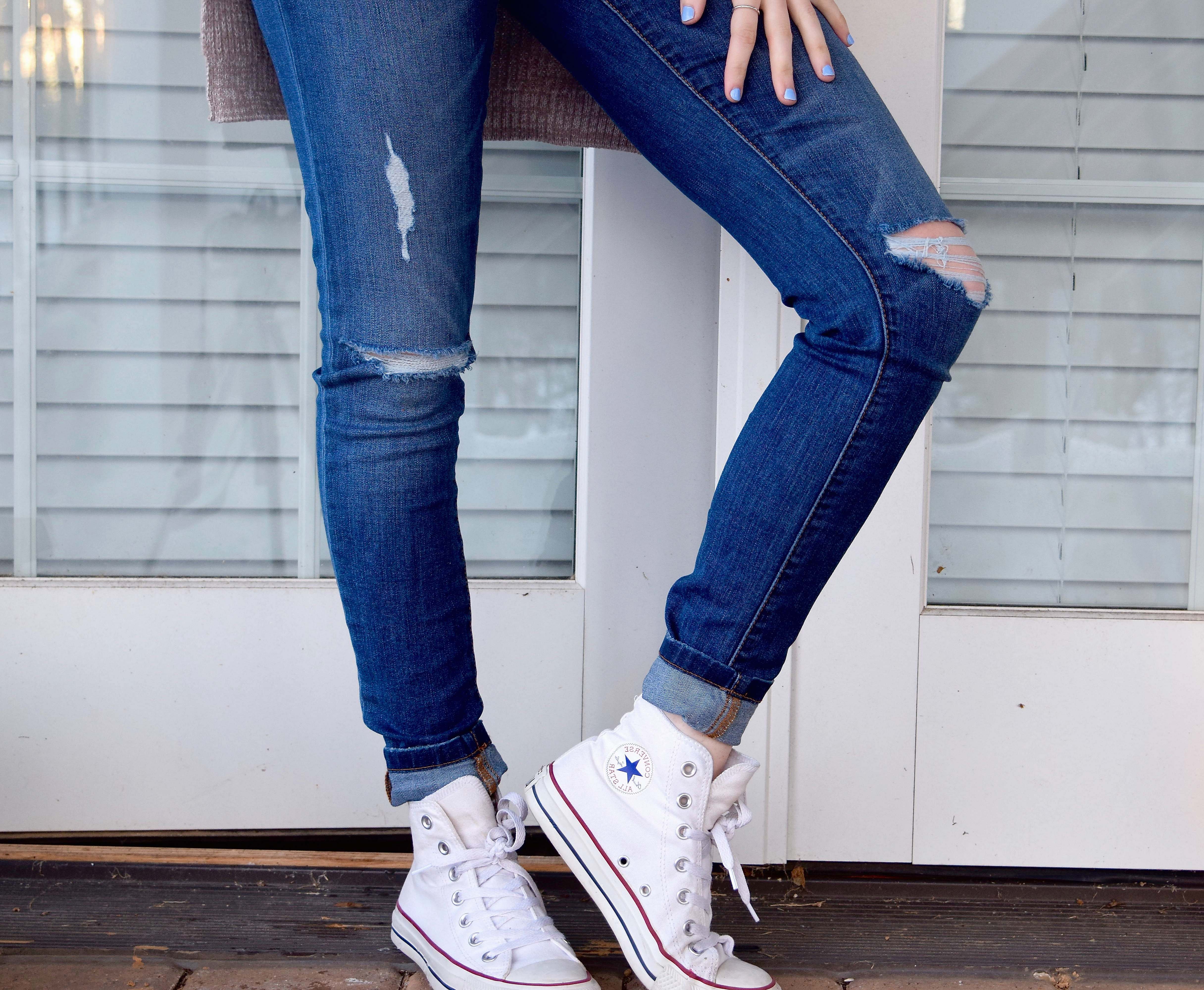 Shoe Women's Distressed Blue Denim Jeans And Pair Of White Converse ...