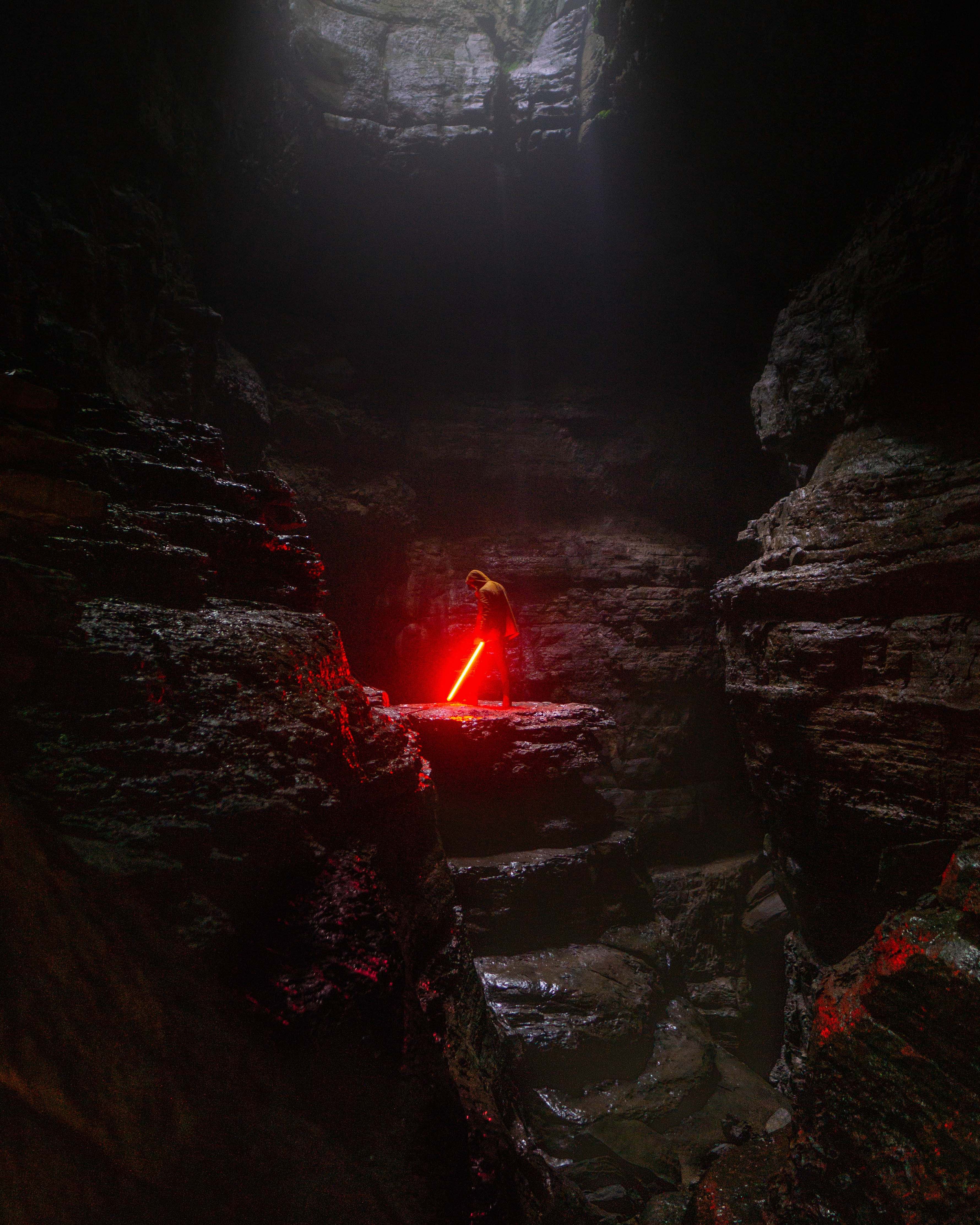 Hole Person Holding Red Lightsaber Nature Image Free Photo