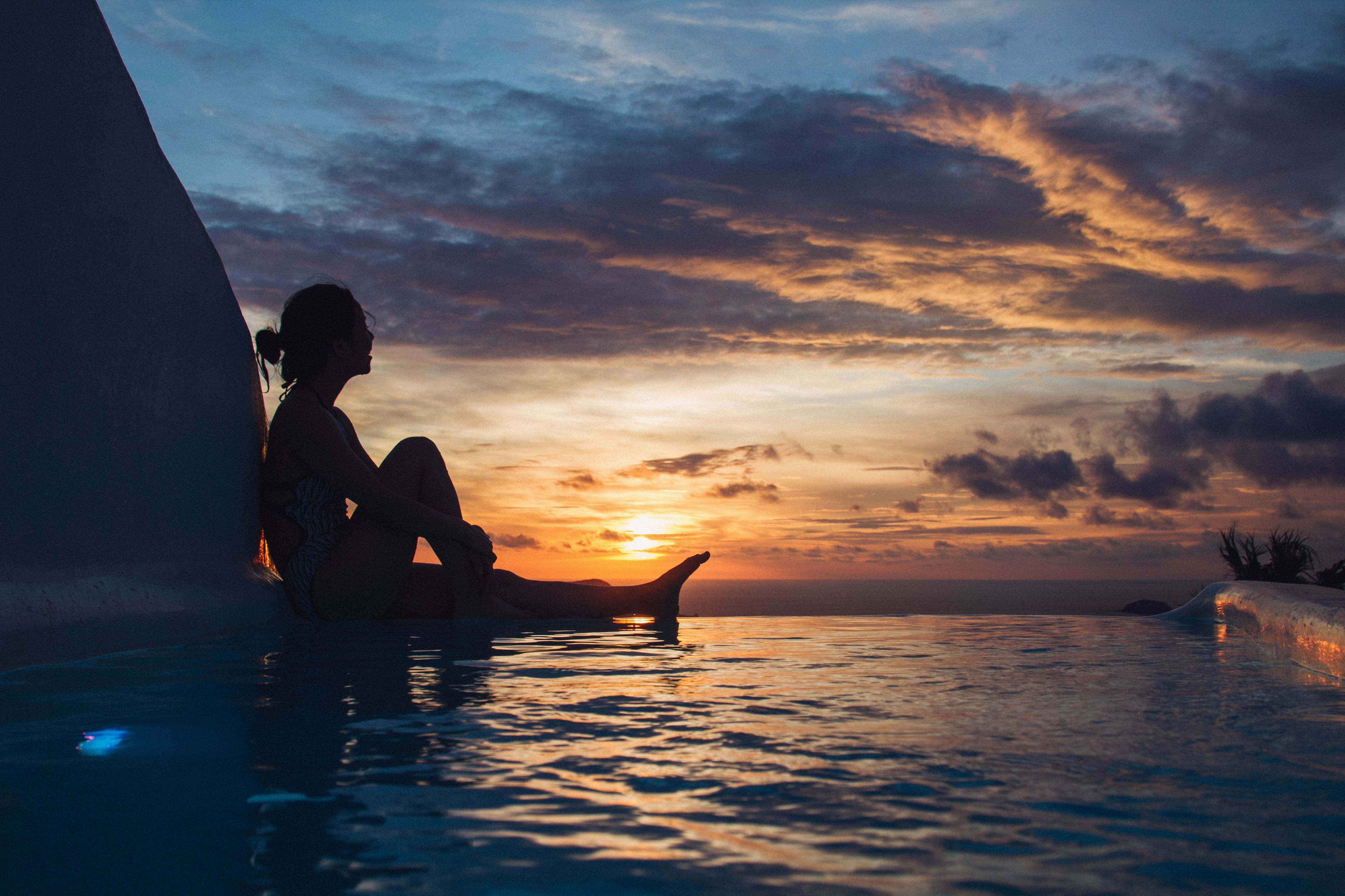 Outdoors Woman Sitting On Pool During Daytime Human Image Free Photo