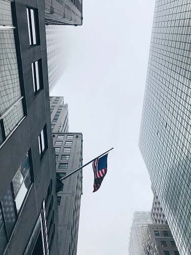 building worm's-eye view photography of flag of American city