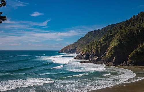 promontory seashore under blue sky coast