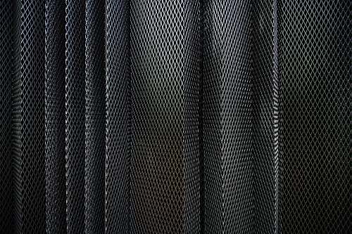 texture A metal criss-cross grid in undulating layers pattern