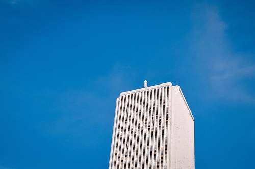 architecture low angle photo of white high-rise building under blue sky skyscraper