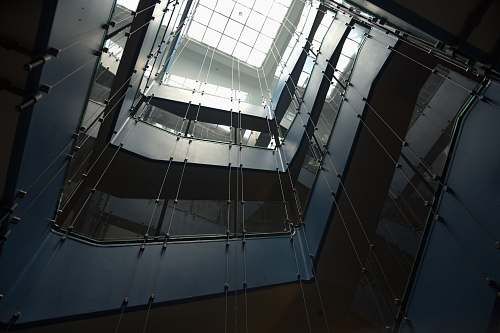 architecture low-angle photography of multi-storey building with glass ceiling window