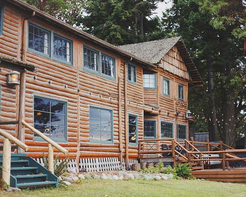 housing orange 2-storey house near trees cabin