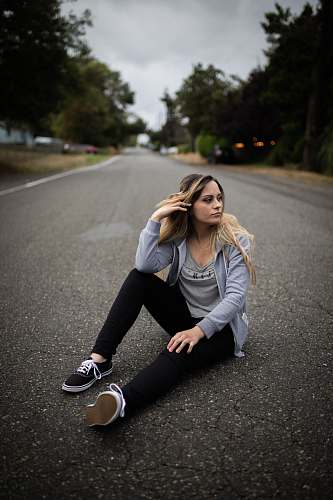 jar woman sitting on empty road plant