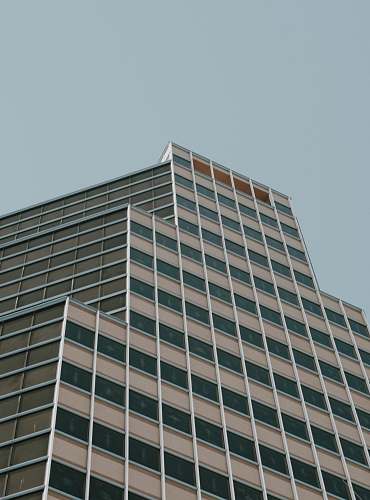 building brown concrete building under blue sky during daytime office building