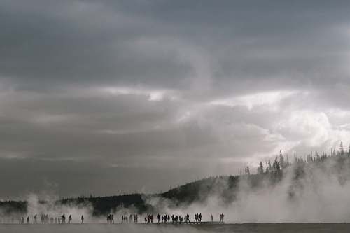steam people near mountain with fogs yellowstone national park