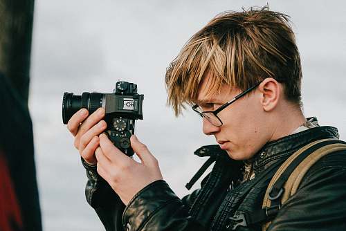 person man holding camera accessories