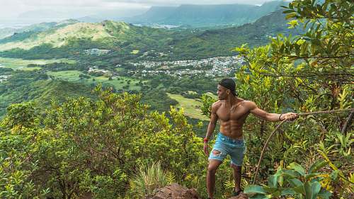 person man holding on rope looking at mountain people