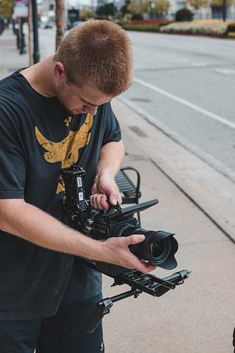 person man holding professional camera people