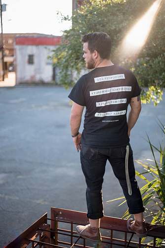 person man standing on brown wired platform clothing