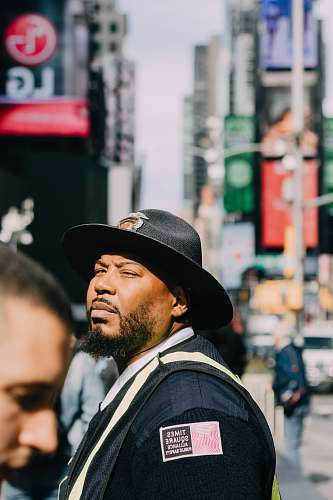 person man standing wearing black hat people