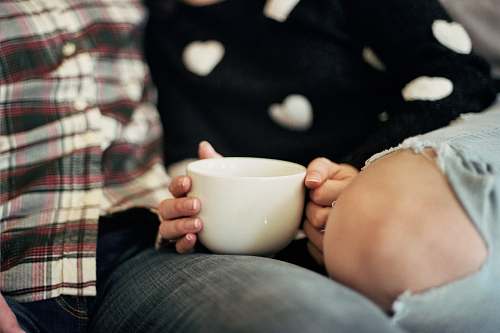 person person holding white ceramic mug people