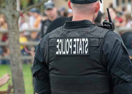 person person wearing black State Police vest people