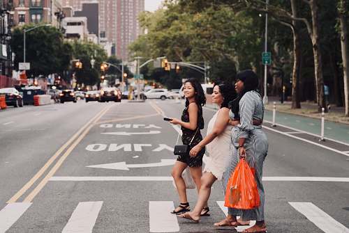 person three women walking on pedestrian lane people